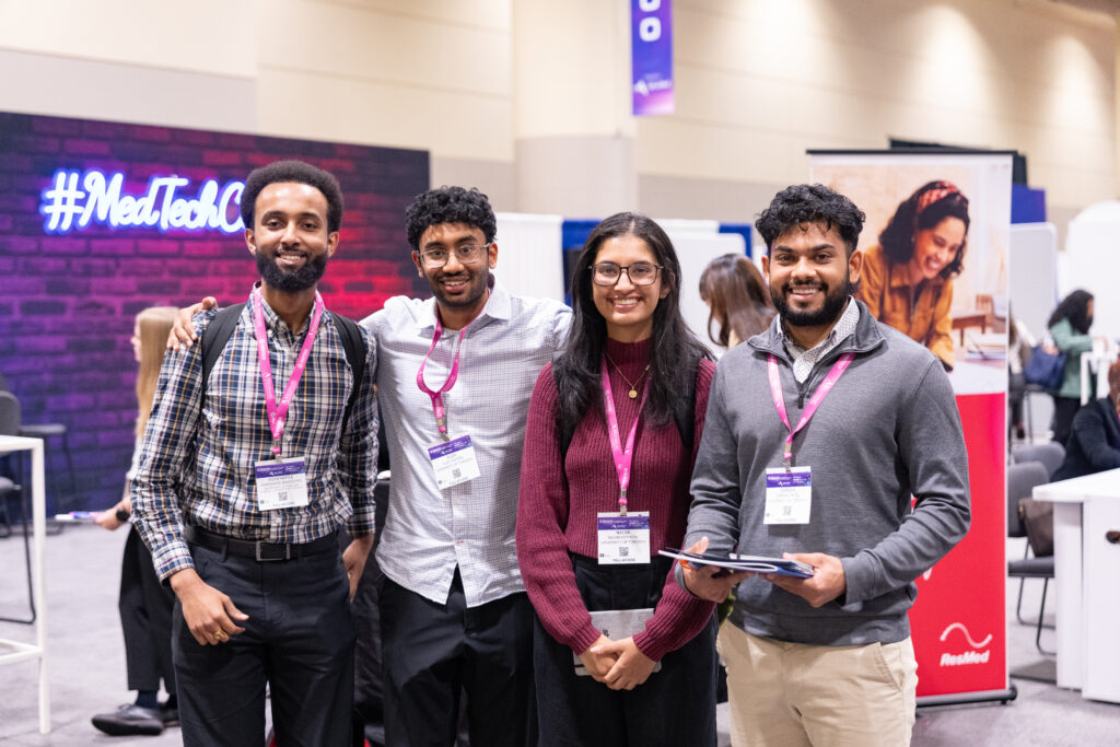 4 people standing next to each other in the medtech gen next hub in 2024 smiling at the camera