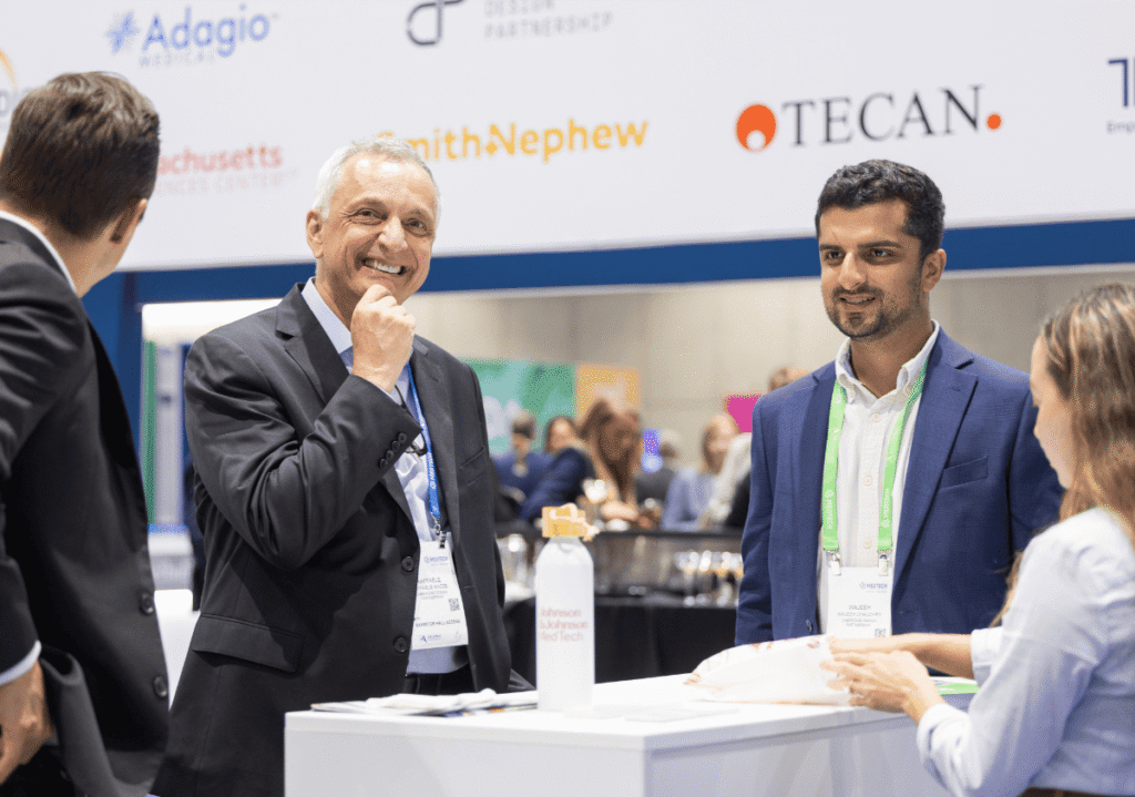 Smiling men in suits at conference