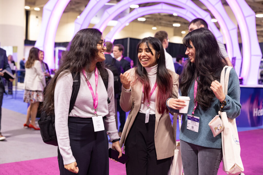 3 women standing and talking to each other at the medtech conference in 2024