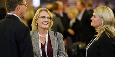 business women smiling in networking reception