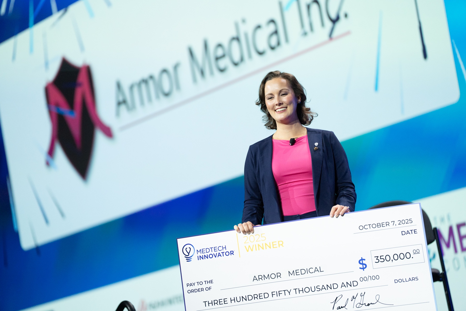 Woman smiling and holding an award after winning an award
